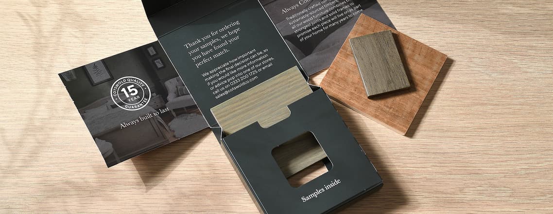 A sample pack of wood tones on a light wooden surface